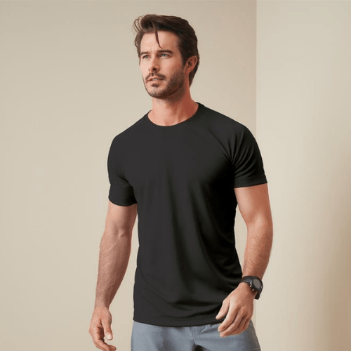 Good looking guy wearing black t-shirt and black watch in plain background.